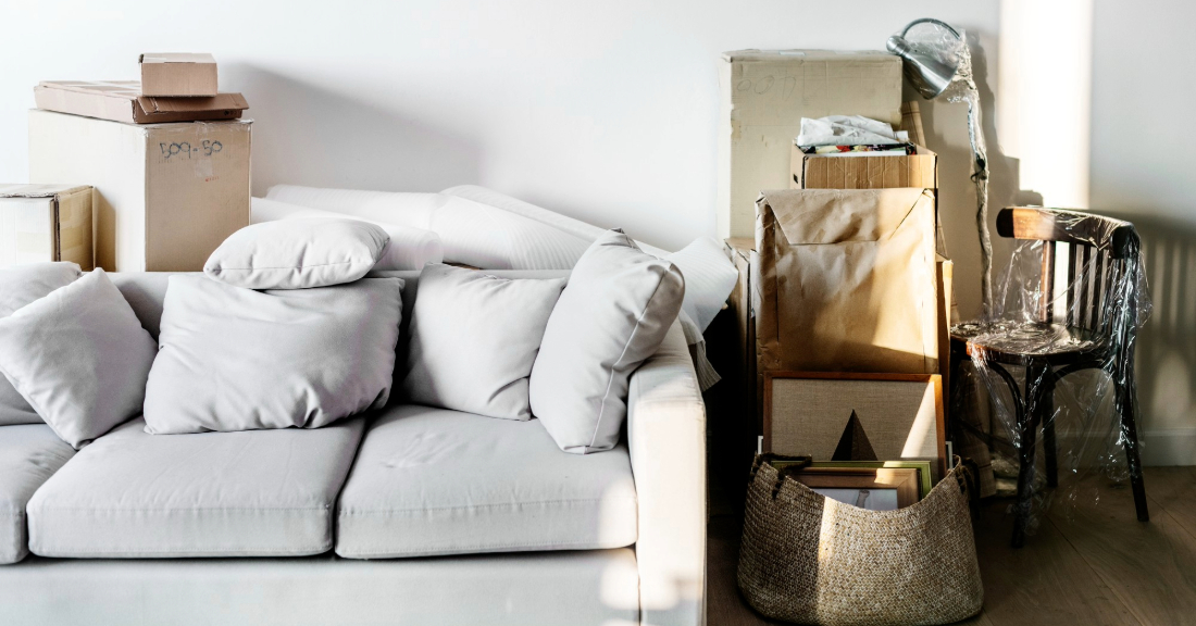 A cozy and stylish small apartment showcasing clever furniture solutions like a wall-mounted desk, storage ottoman, and slim dining bench.