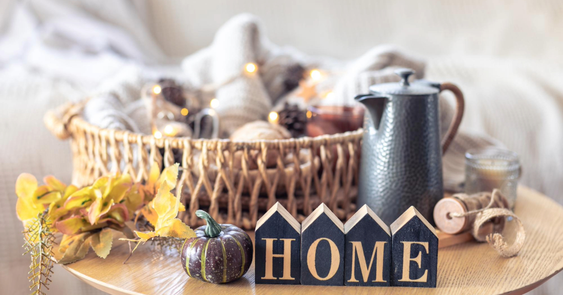 Rustic fall centerpiece made with leaves, pinecones, and dried branches in a glass vase.
