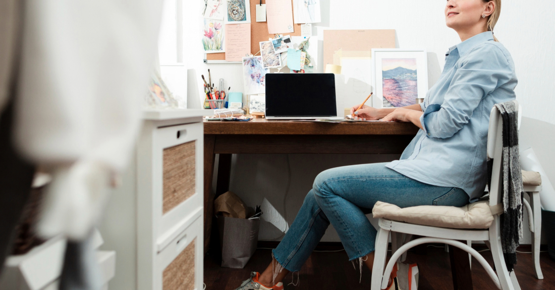 A cozy guest-ready home office with a compact desk, stylish sofa bed, and warm lighting that balances work and comfort.