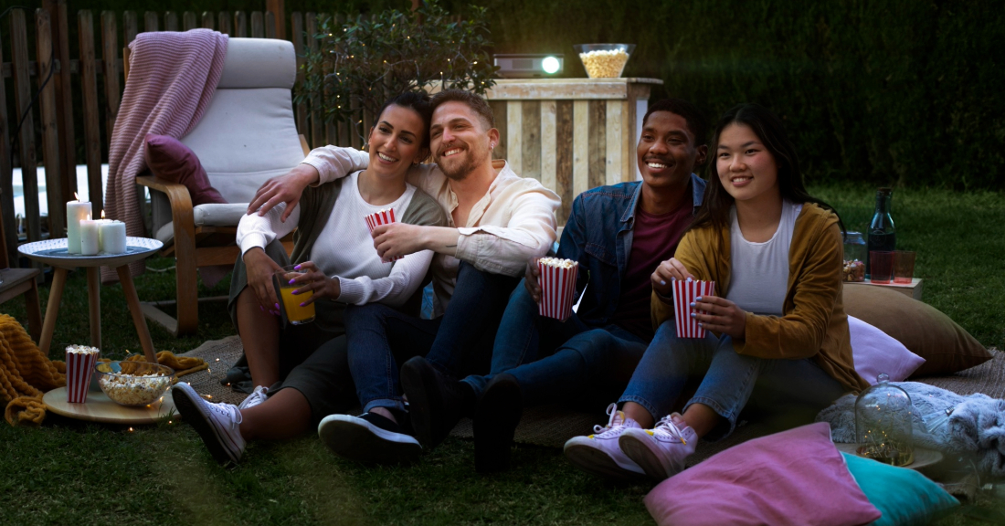 Versatile summer furniture setup with outdoor dining, cozy sectional, lounge chairs, and firepit seating for backyard BBQs and movie nights.