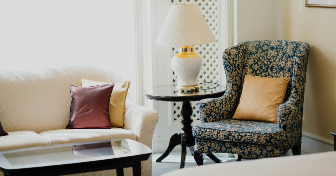 Cozy living room with wooden accent table and warm-toned décor.