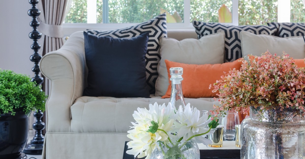 Modern living room with couch, coffee table, and flowers